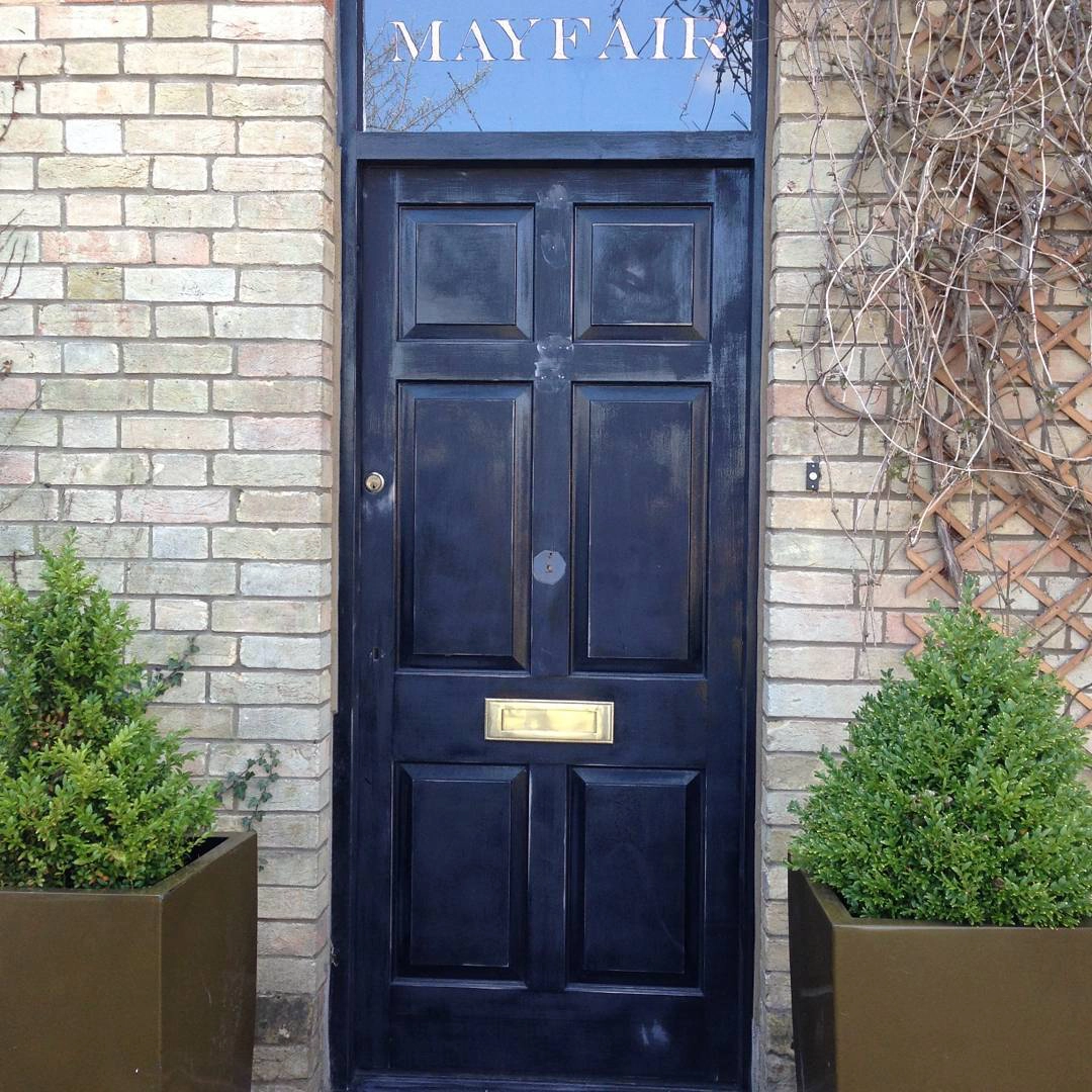 Black door with Mayfair sign above.