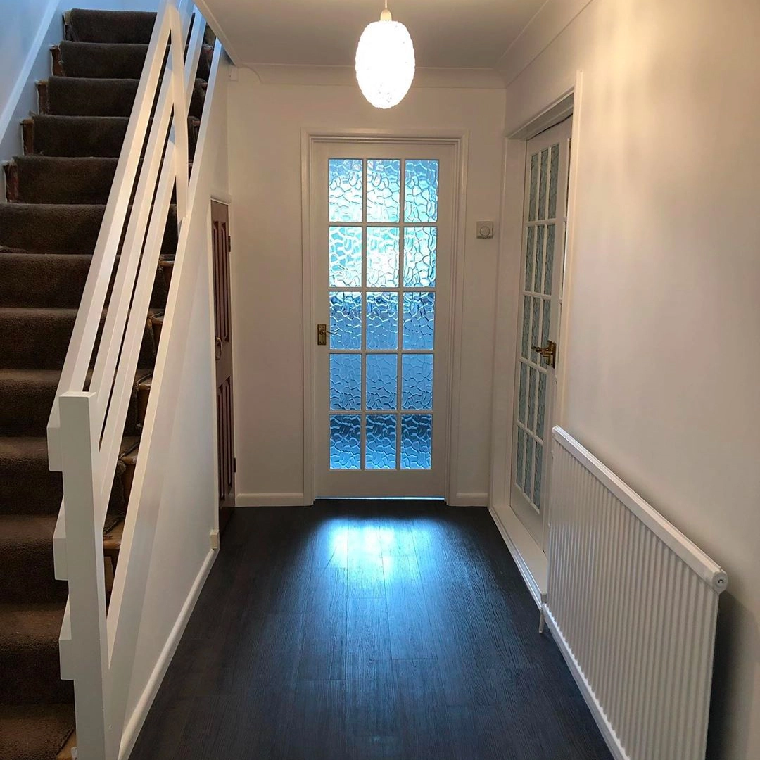 Modern hallway with stairs and glass doors