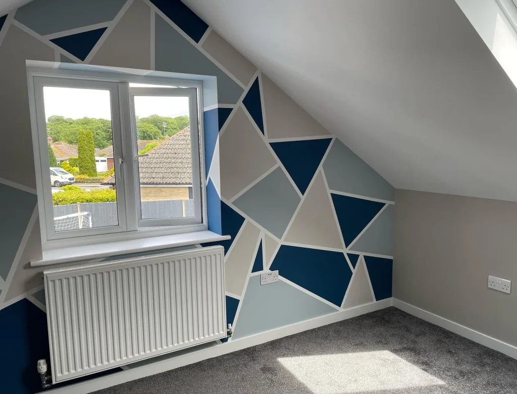 Geometric feature wall with blue and grey patterns.
