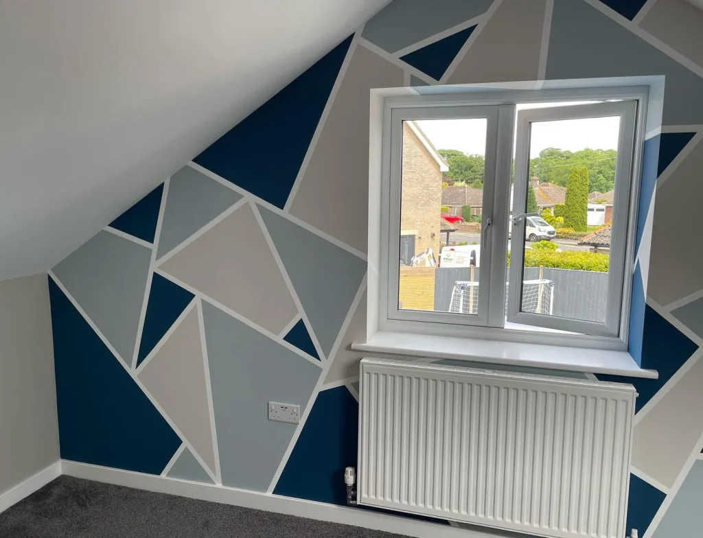 Geometric feature wall in modern loft room.