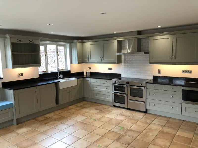 A sage-green shaker kitchen, freshly sprayed