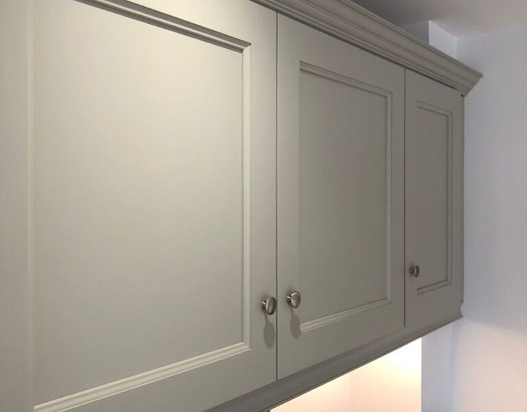 Grey shaker kitchen wall cabinets with underlighting