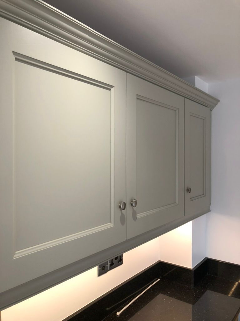 Pale grey wall cabinets sprayed in a soft matt finish