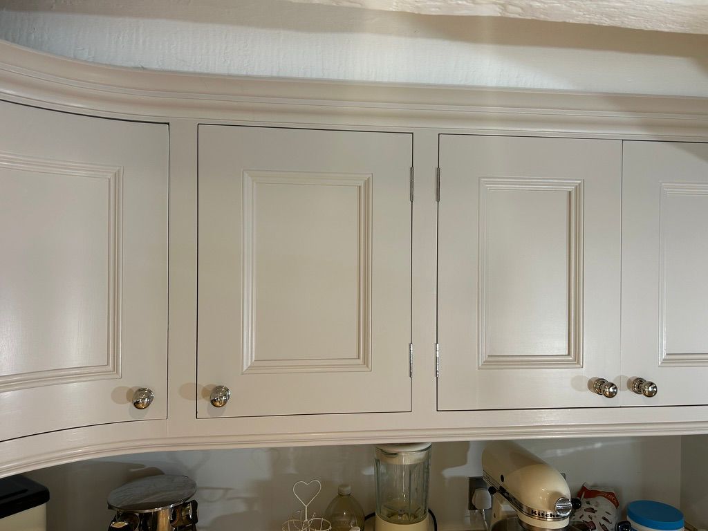 Cream wall cabinets resprayed with a smooth painted finish