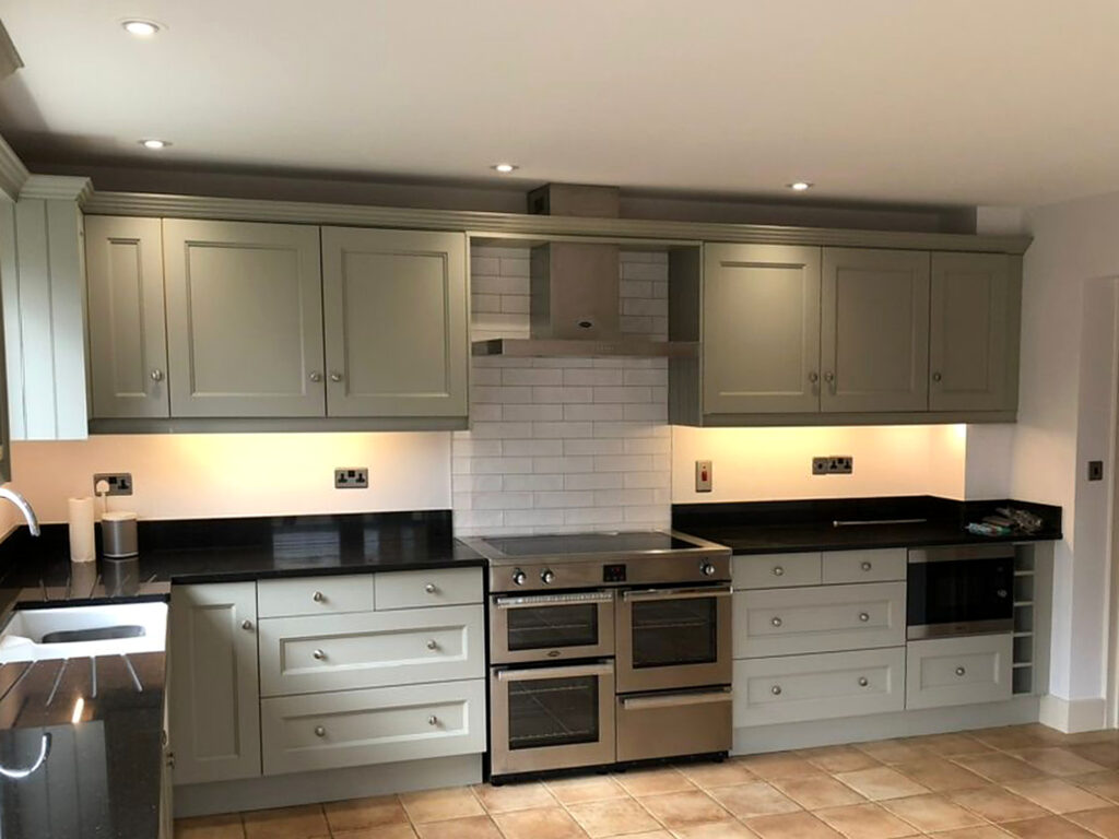 After: kitchen resprayed in sage green
