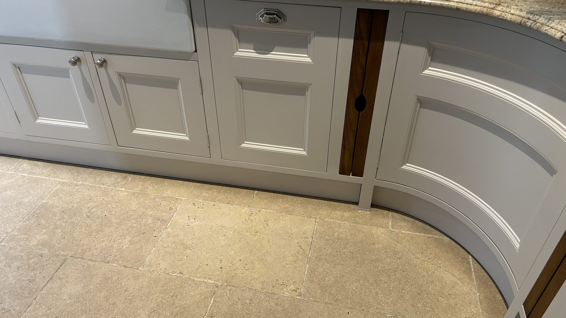 A resprayed cream kitchen with a curved island