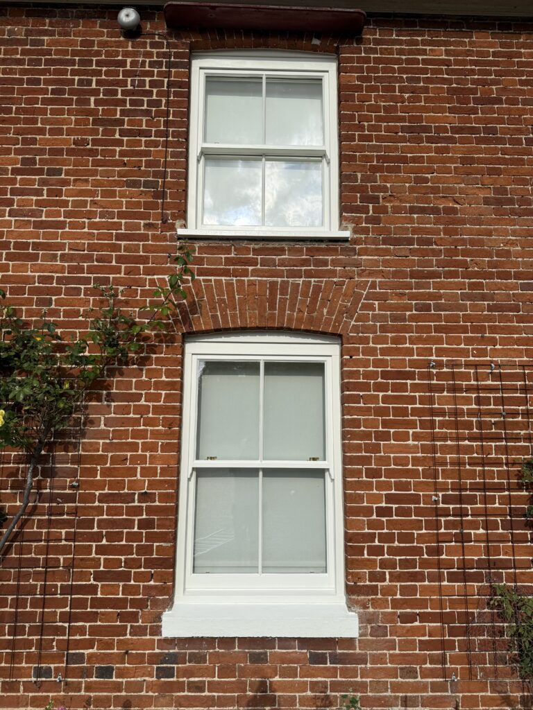 Red brick house with white sash windows