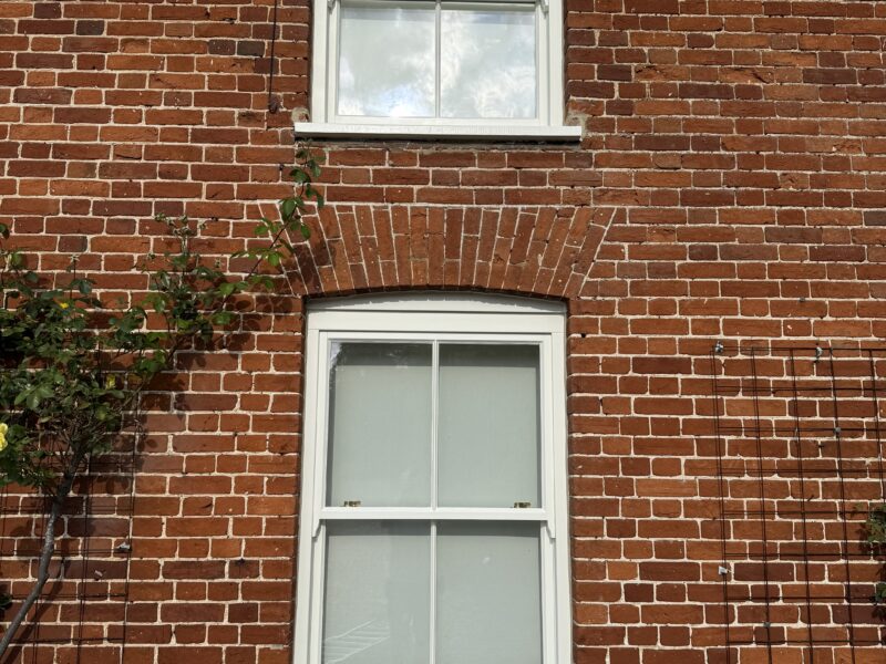 Red brick house with white sash windows