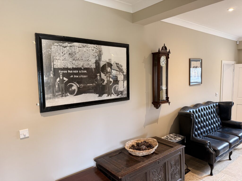 Framed vintage lorry photo above leather armchair