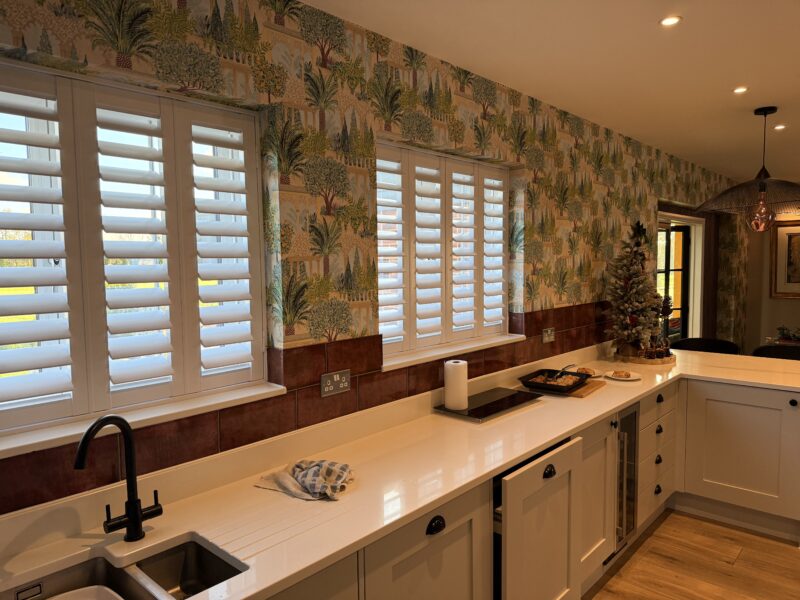 Modern kitchen with shutters and tropical wallpaper